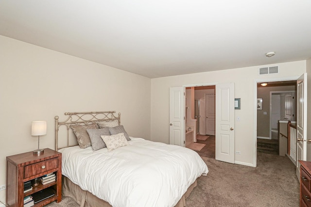 bedroom featuring baseboards, visible vents, and carpet