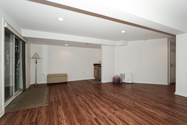 below grade area featuring recessed lighting, baseboards, and dark wood finished floors
