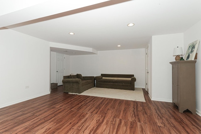 living room featuring baseboards, wood finished floors, and recessed lighting