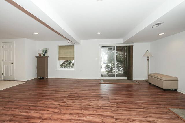 unfurnished living room featuring baseboards, visible vents, wood finished floors, and recessed lighting