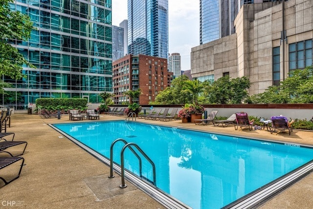 community pool featuring a view of city and a patio