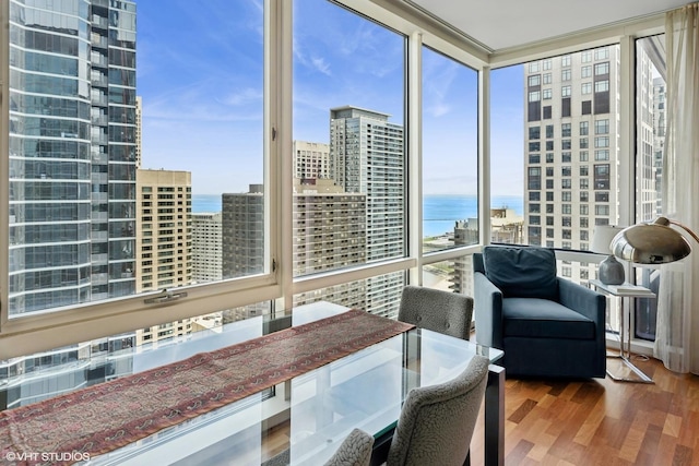 sunroom / solarium with a water view and a view of city