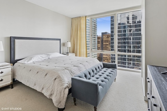 carpeted bedroom featuring a wall of windows and a city view