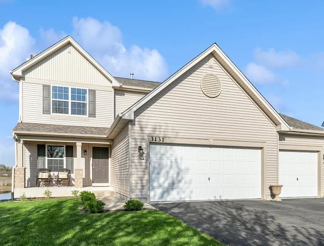 3131 Braeburn Ct, Woodstock, IL 60098 - view of front of home featuring driveway, covered porch, a garage, and a front lawn