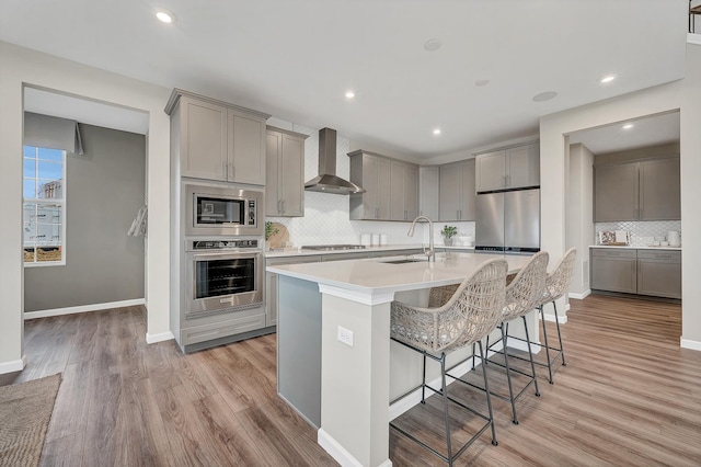 2547 Mallet Ct, Naperville, IL 60564 - kitchen featuring a sink, open floor plan, light wood-style floors, appliances with stainless steel finishes, and gray cabinetry