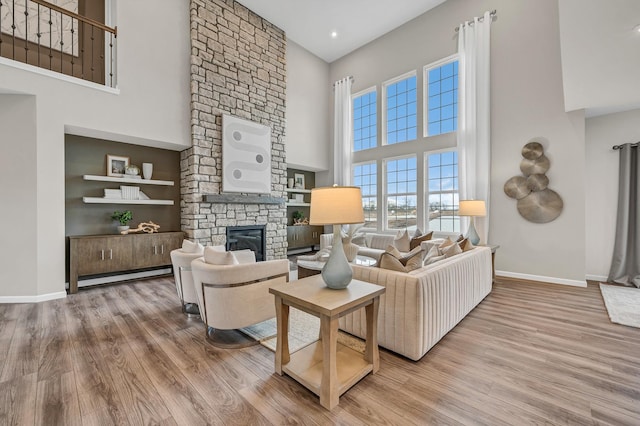 2547 Mallet Ct, Naperville, IL 60564 - living area featuring a stone fireplace, wood finished floors, visible vents, and baseboards