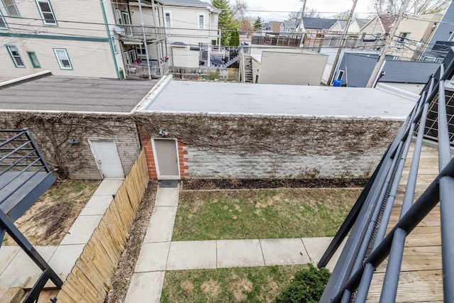 view of yard featuring a balcony and a residential view