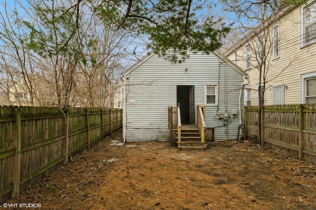 back of property featuring a fenced backyard