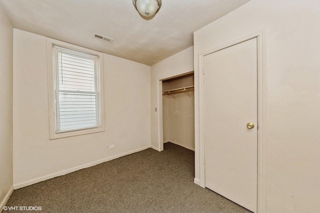 unfurnished bedroom with baseboards, visible vents, a closet, and carpet
