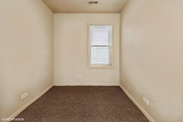 spare room with carpet floors, baseboards, and visible vents
