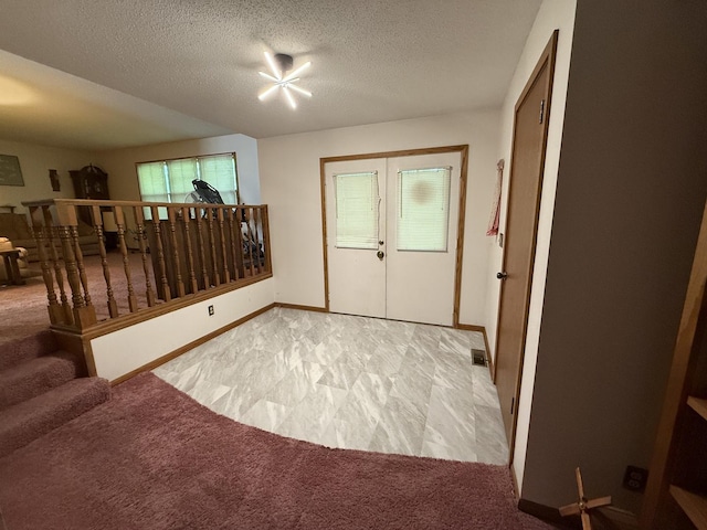 203 S Whitehead St, Tolono, IL 61880 - foyer with a textured ceiling and light colored carpet