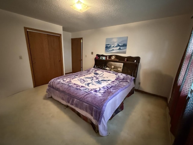 203 S Whitehead St, Tolono, IL 61880 - bedroom featuring carpet floors, a closet, and a textured ceiling
