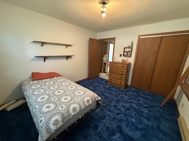 203 S Whitehead St, Tolono, IL 61880 - carpeted bedroom with a closet, a baseboard radiator, and a textured ceiling