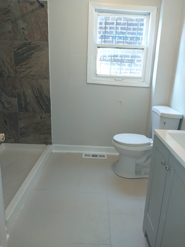 bathroom with toilet, a stall shower, baseboards, and visible vents
