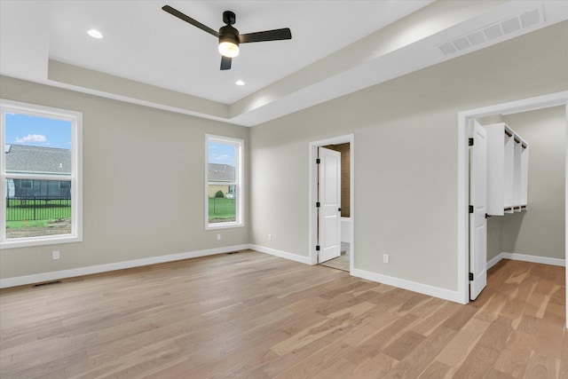 2816 Clarion Rd, Urbana, IL 61802 - unfurnished bedroom with light wood-style flooring, multiple windows, baseboards, a walk in closet, and recessed lighting