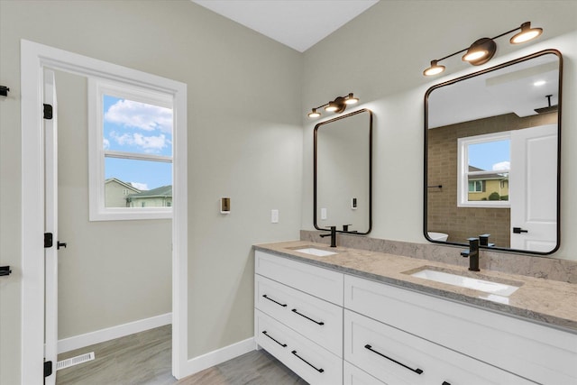 2816 Clarion Rd, Urbana, IL 61802 - bathroom featuring double vanity, baseboards, and wood finished floors