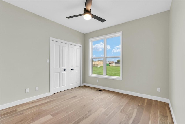 2816 Clarion Rd, Urbana, IL 61802 - unfurnished bedroom with light wood-type flooring, baseboards, a closet, and a ceiling fan