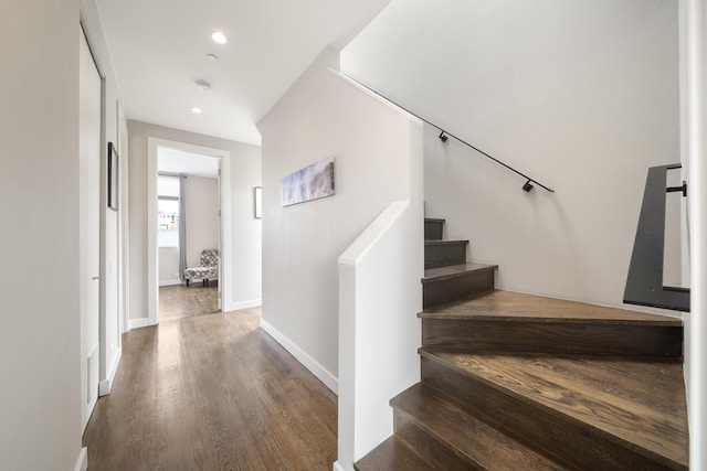stairway featuring baseboards, recessed lighting, and wood finished floors