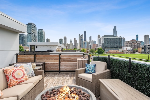 exterior space with a city view and an outdoor living space with a fire pit