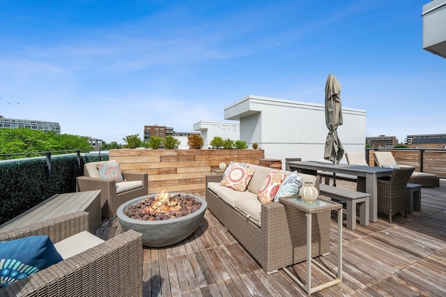 wooden deck featuring an outdoor living space with a fire pit and outdoor dining space