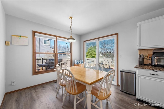 dining room with baseboards and dark wood-style flooring