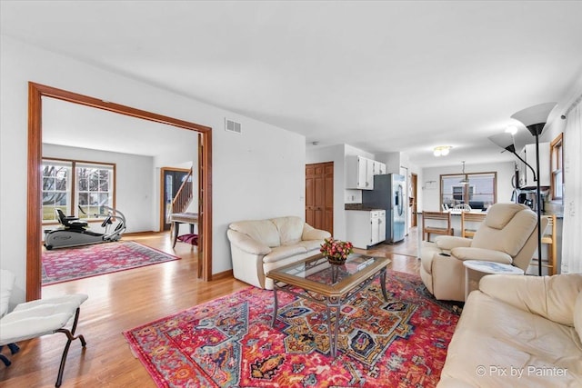 living room featuring light wood finished floors and visible vents