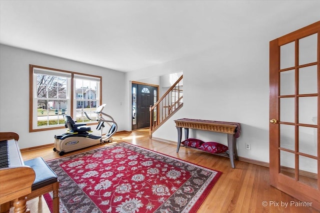 interior space featuring baseboards, wood finished floors, and stairway