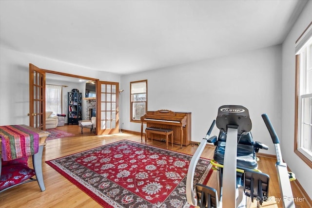 interior space featuring french doors, baseboards, and wood finished floors