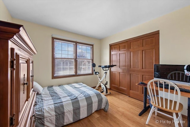 bedroom with a closet and light wood-style floors