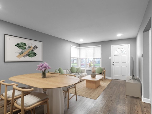 dining area featuring baseboards, wood finished floors, and recessed lighting