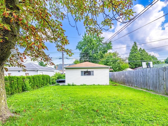 view of yard featuring an outdoor structure and fence