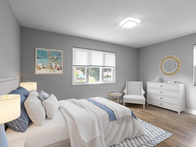 bedroom featuring baseboards and wood finished floors