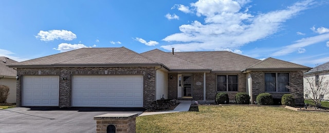 ranch-style house with a garage, brick siding, a front lawn, driveway, and a shingled roof