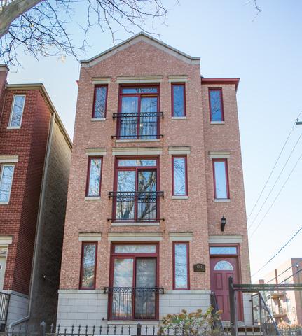 4312 S Saint Lawrence Ave Unit 1, Chicago, IL 60653 - view of front facade with brick siding and a fenced front yard