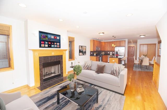 4312 S Saint Lawrence Ave Unit 1, Chicago, IL 60653 - living room with recessed lighting, a tiled fireplace, and light wood finished floors