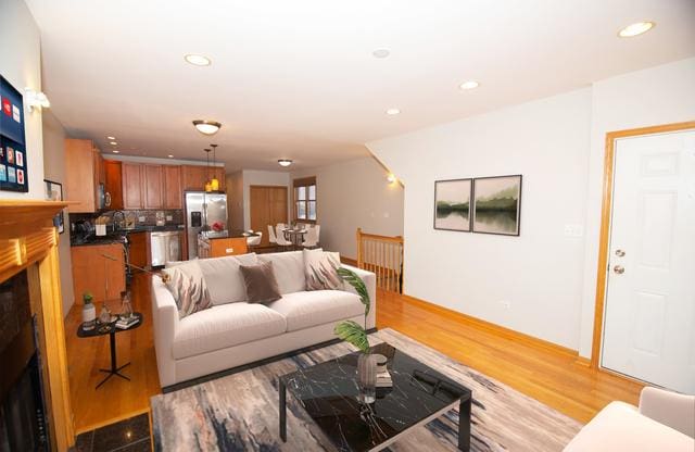 4312 S Saint Lawrence Ave Unit 1, Chicago, IL 60653 - living area featuring light wood-style flooring, a fireplace, and recessed lighting
