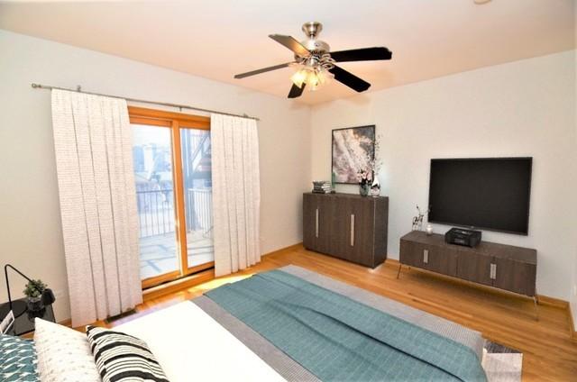 4312 S Saint Lawrence Ave Unit 1, Chicago, IL 60653 - bedroom with a ceiling fan, access to outside, and wood finished floors