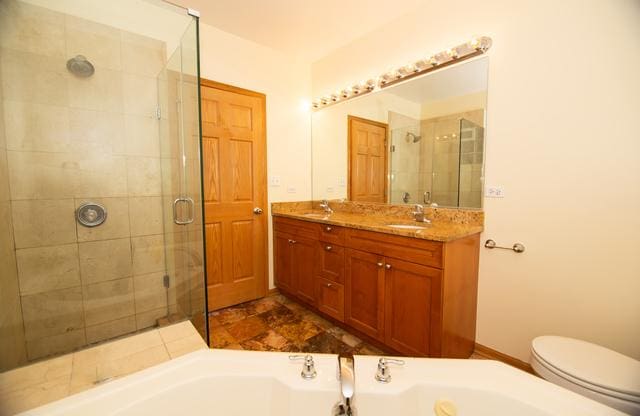 4312 S Saint Lawrence Ave Unit 1, Chicago, IL 60653 - full bath featuring a sink, a garden tub, a shower stall, baseboards, and double vanity