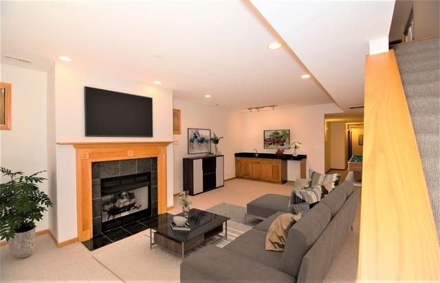 4312 S Saint Lawrence Ave Unit 1, Chicago, IL 60653 - living area featuring track lighting, carpet floors, a tile fireplace, and recessed lighting