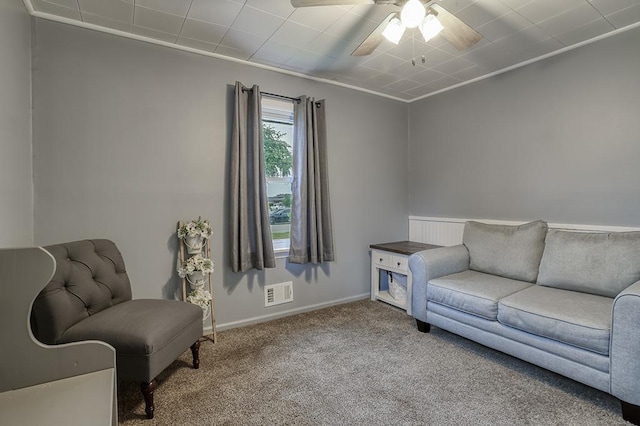 living area featuring carpet flooring, ceiling fan, and baseboards