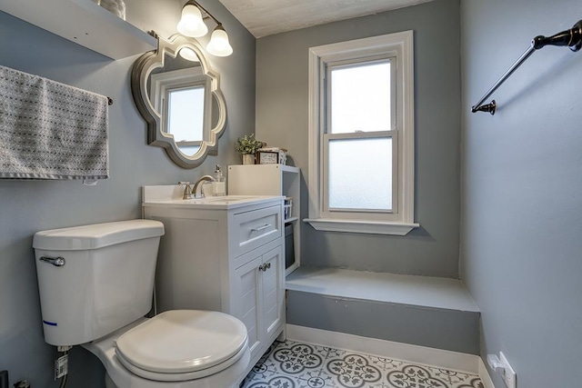 bathroom with plenty of natural light and toilet