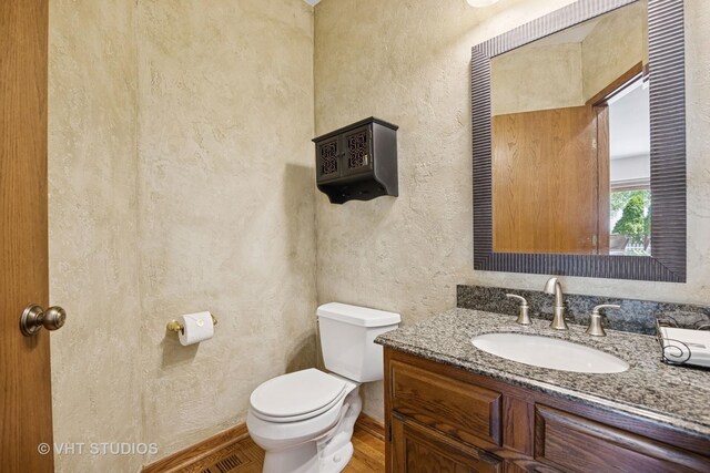4230 Forest Glen Dr, Hoffman Estates, IL 60192 - bathroom featuring a textured wall, toilet, vanity, and wood finished floors