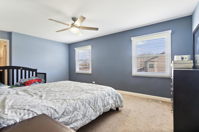 bedroom with carpet floors, baseboards, a ceiling fan, and visible vents