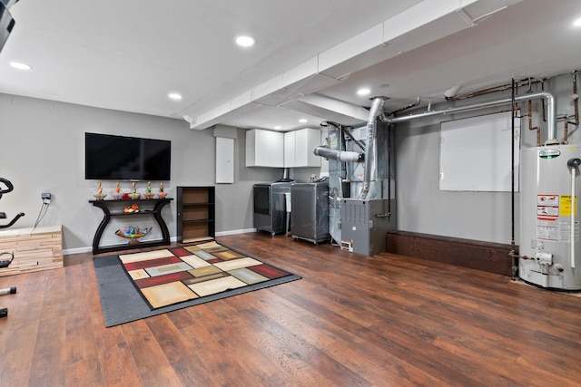 finished basement featuring water heater, baseboards, recessed lighting, washer and clothes dryer, and wood finished floors