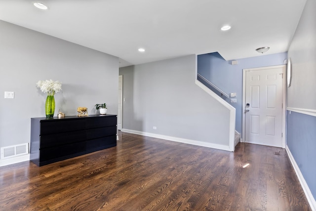 interior space featuring dark wood finished floors, visible vents, recessed lighting, stairs, and baseboards