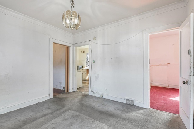 9241 S Blackstone Ave, Chicago, IL 60619 - carpeted empty room featuring visible vents, crown molding, and an inviting chandelier
