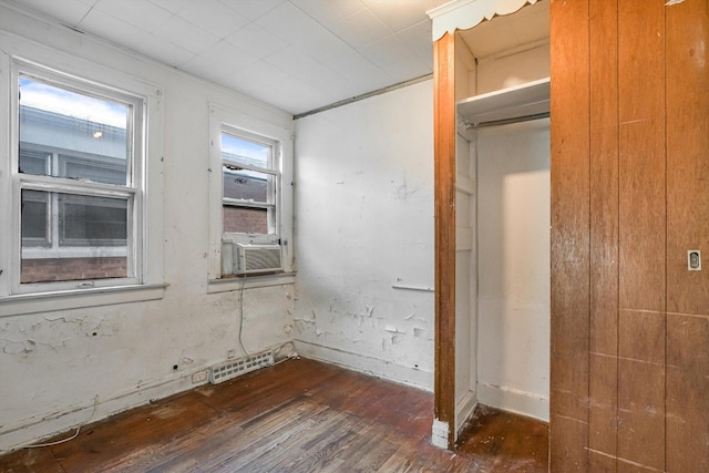 9241 S Blackstone Ave, Chicago, IL 60619 - unfurnished bedroom with cooling unit, dark wood-style flooring, and visible vents