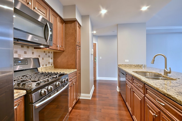 7420 W Lawrence Ave Unit 402, Harwood Heights, IL 60706 - kitchen with stainless steel appliances, a sink, brown cabinets, light stone counters, and tasteful backsplash