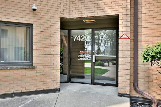 7420 W Lawrence Ave Unit 402, Harwood Heights, IL 60706 - doorway to property featuring brick siding and a security system