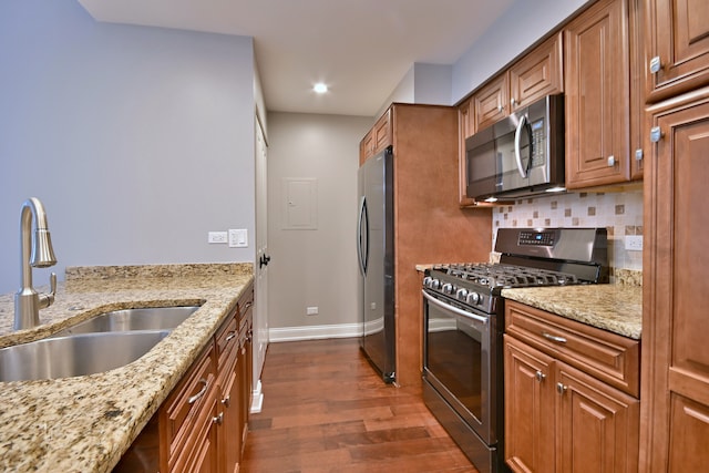 7420 W Lawrence Ave Unit 402, Harwood Heights, IL 60706 - kitchen featuring stainless steel appliances, a sink, dark wood-type flooring, baseboards, and brown cabinetry